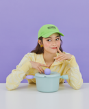 Lifestyle image with model in green cap using Better Finger casserole – fun and functional kitchenware