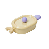 Better Finger 10" Casserole with pastel yellow rectangular ceramic body, dual purple ball handles, and matching lid on white background